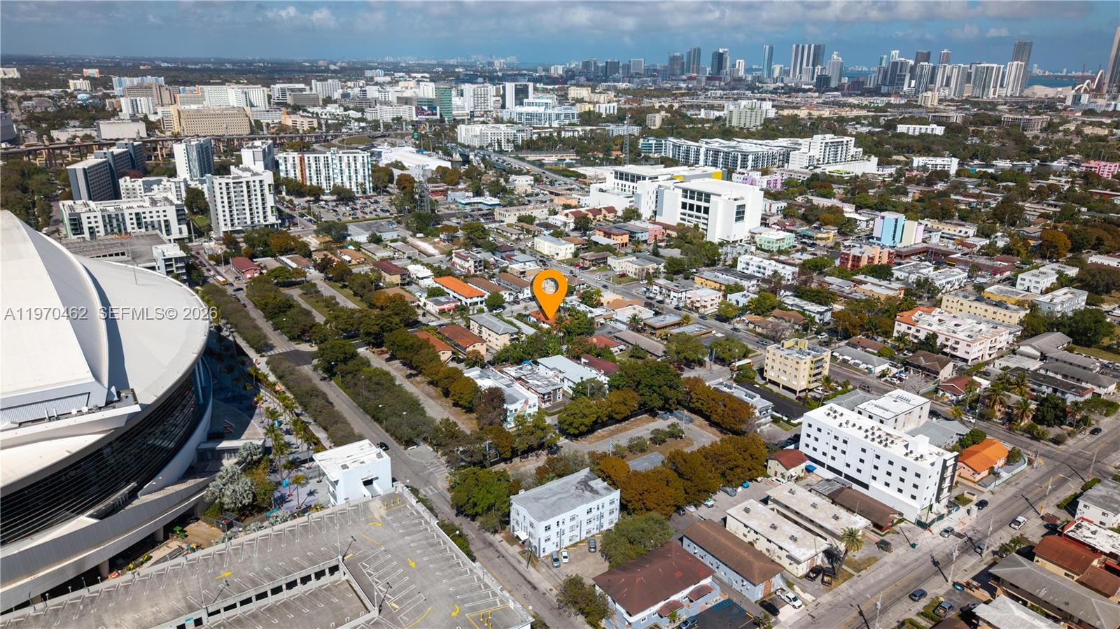 This aerial view shows a residential neighborhood near a large stadium and city skyline — 1330 NW 5th St # 5, Miami FL 33125, MIAMI, FL