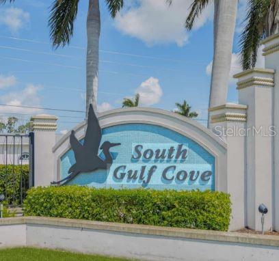 A sign for South Gulf Cove stands in front of palm trees and green hedges — 9417 SUNDANCE STREET, PORT CHARLOTTE, FL