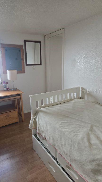 A bedroom features a white bed frame with storage drawers, a wooden desk, and a mirror — 1398 IBIS DRIVE, ENGLEWOOD, FL