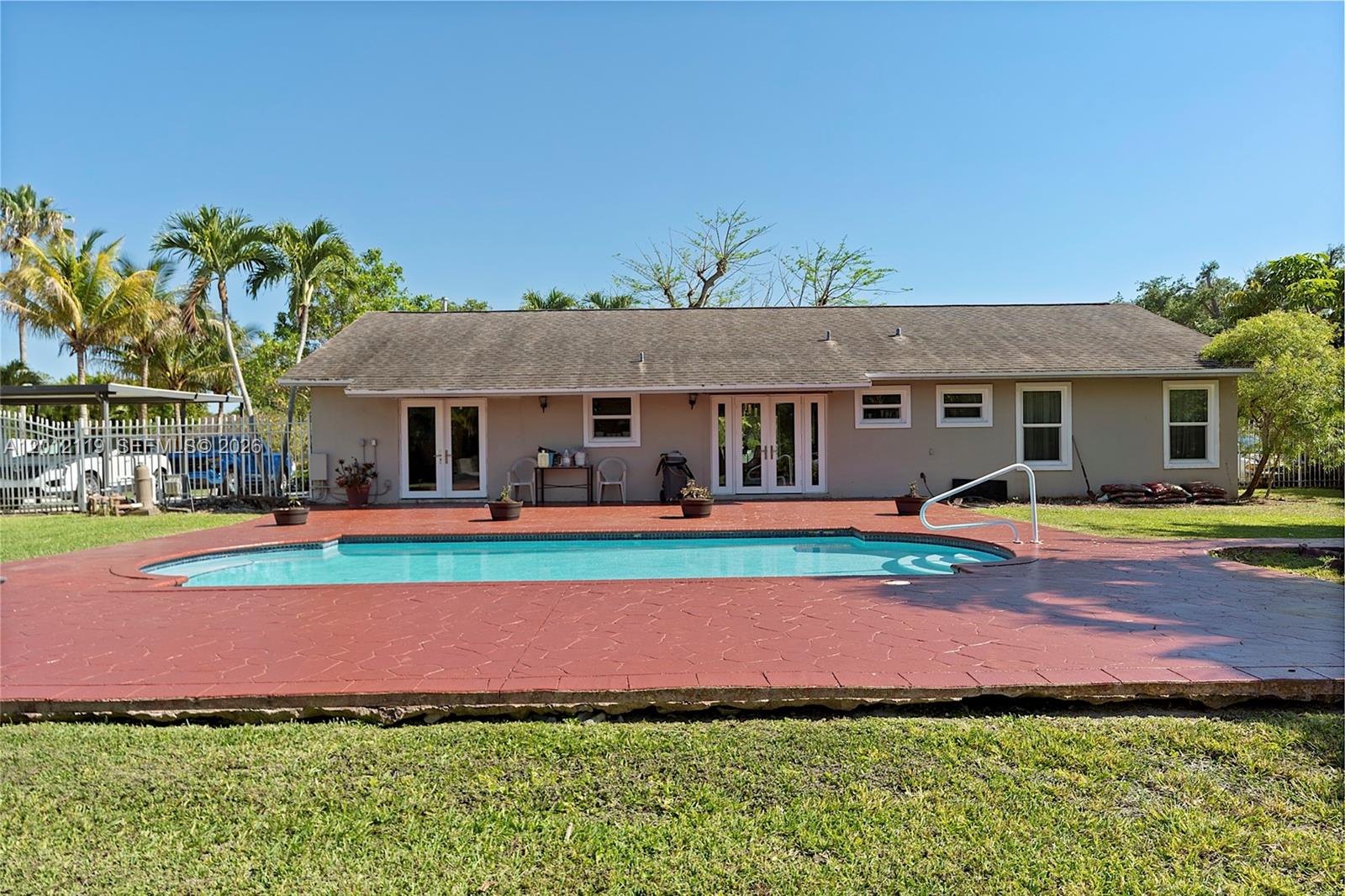 A single-story house with a backyard swimming pool and a red stamped concrete patio — 8895 SW 184th Ter, Cutler Bay FL 33157, CUTLER BAY, FL
