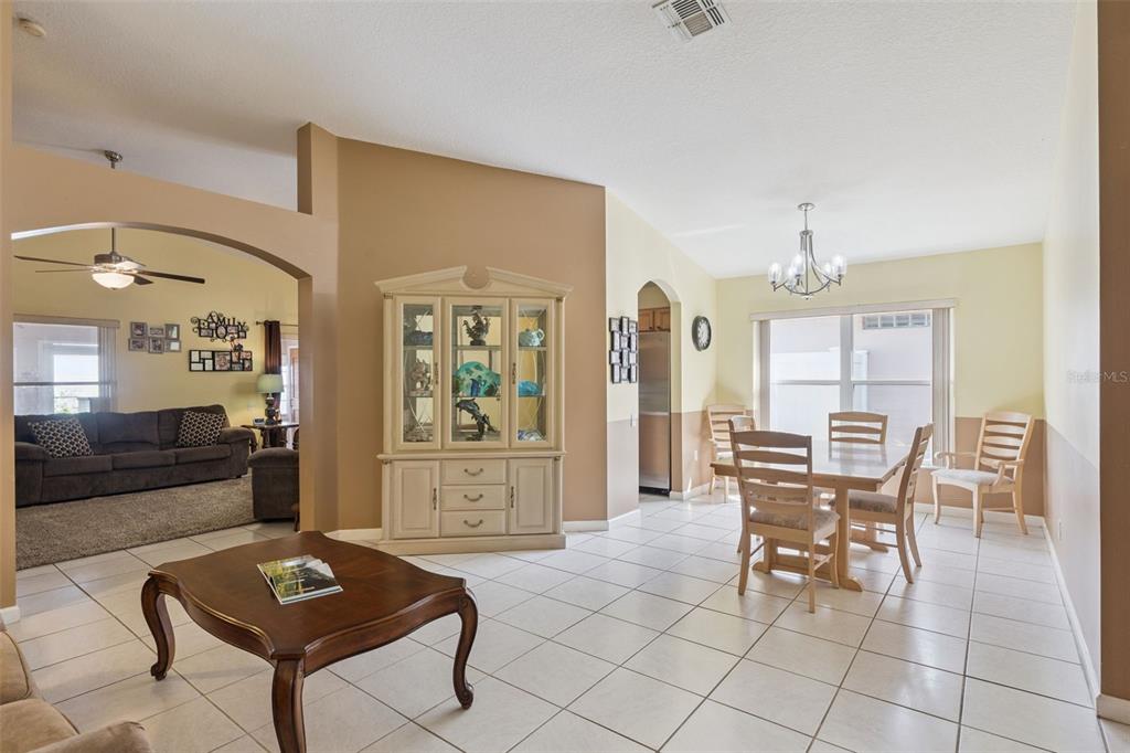 A dining area with a tile floor, a wooden hutch, and a table with chairs — 3136 CRANES COVE LOOP, KISSIMMEE, FL