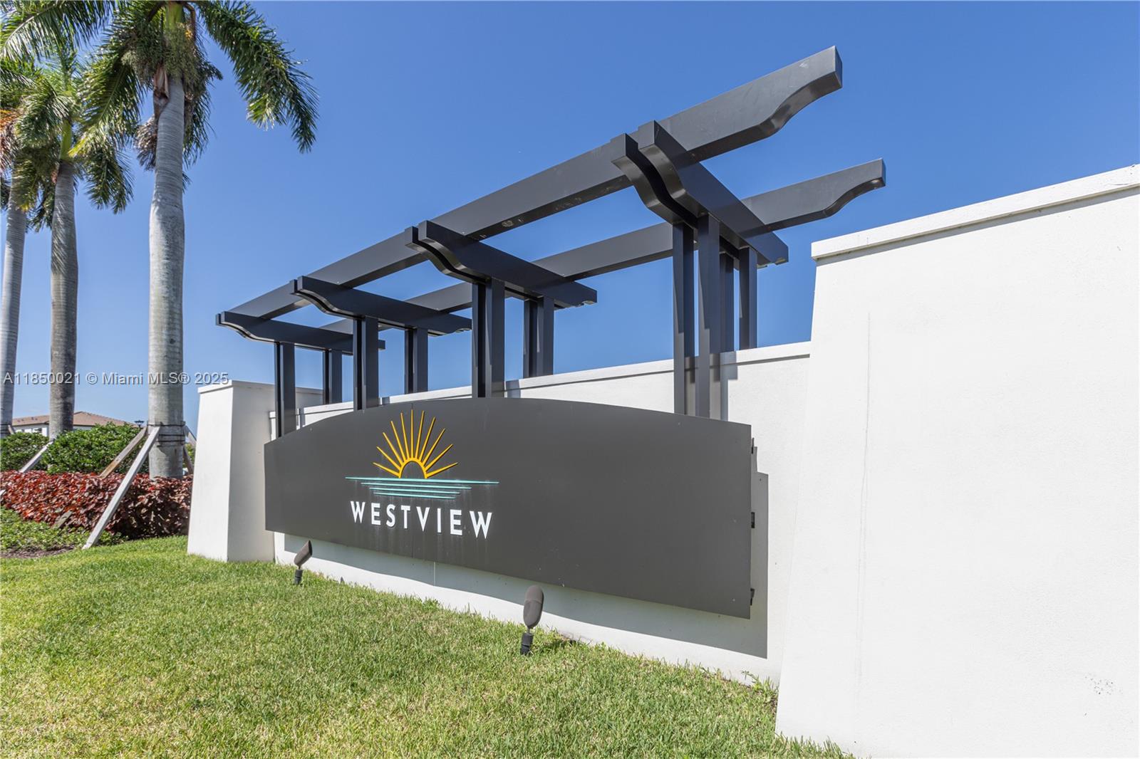 A modern Westview community entrance sign stands on a grassy lawn under a blue sky — 12561 NW 23rd Pl, Miami FL 33167, MIAMI, FL