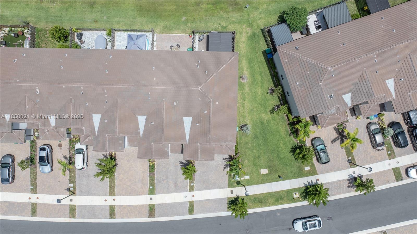 An aerial view shows two rows of townhomes with driveways, lawns, and parked cars — 12561 NW 23rd Pl, Miami FL 33167, MIAMI, FL