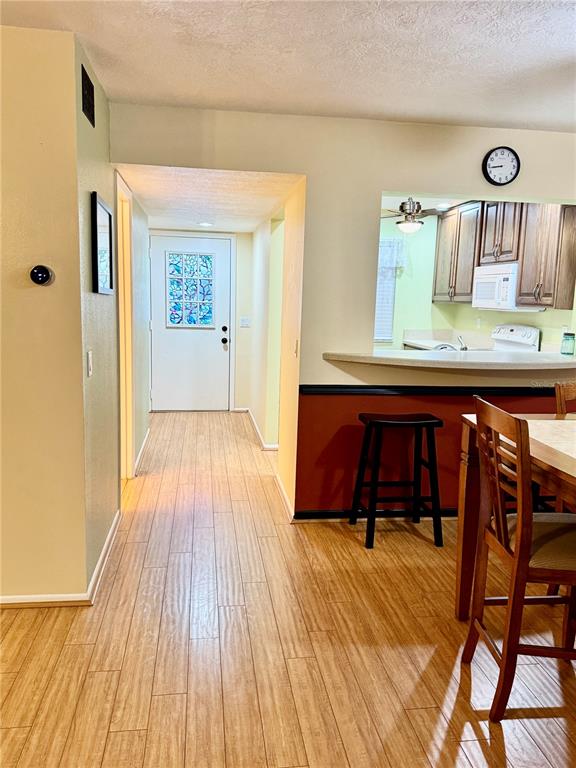 A view from a dining area looking toward a hallway with a front door — 7 MOSER COURT N, HOMOSASSA, FL