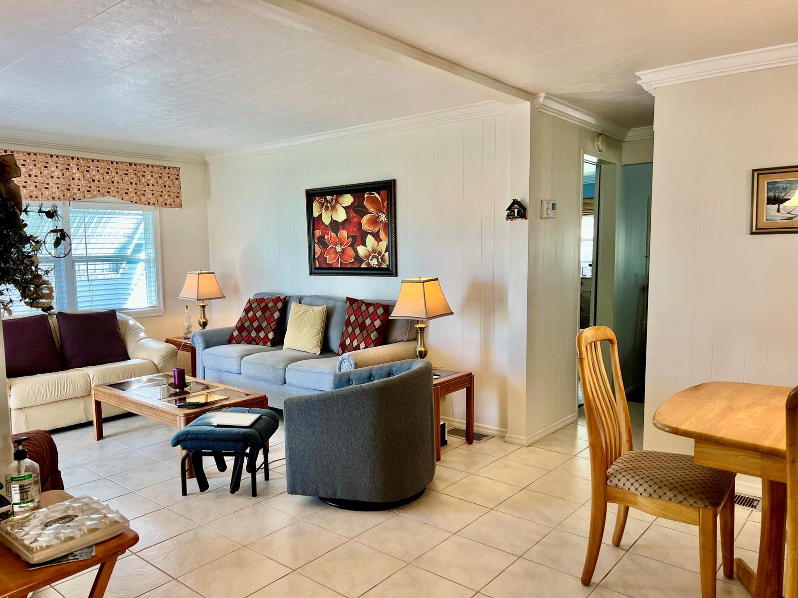 A living room with light tile flooring, a gray sofa, and a dining area — 1552 S 33rd Road, Hollywood FL 33021, HOLLYWOOD, FL