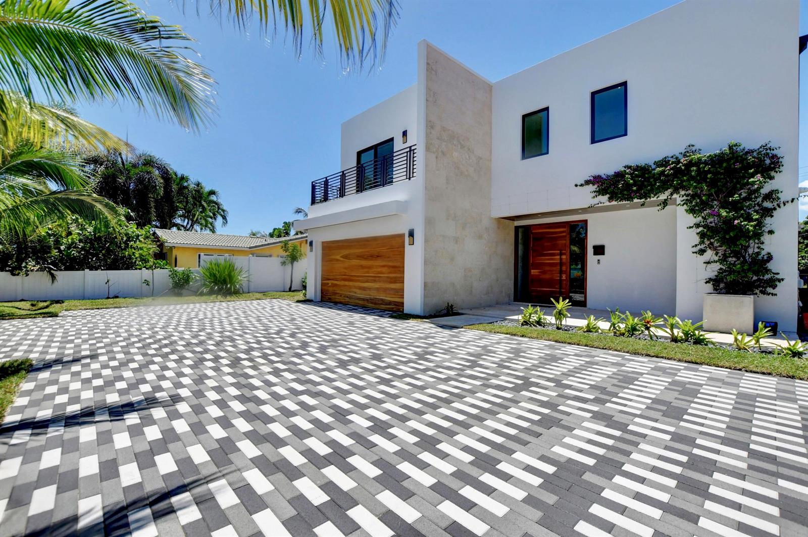 A modern two-story house with a wooden garage door and a patterned paver driveway — 855 NW 4th Avenue, Boca Raton FL 33432, BOCA RATON, FL