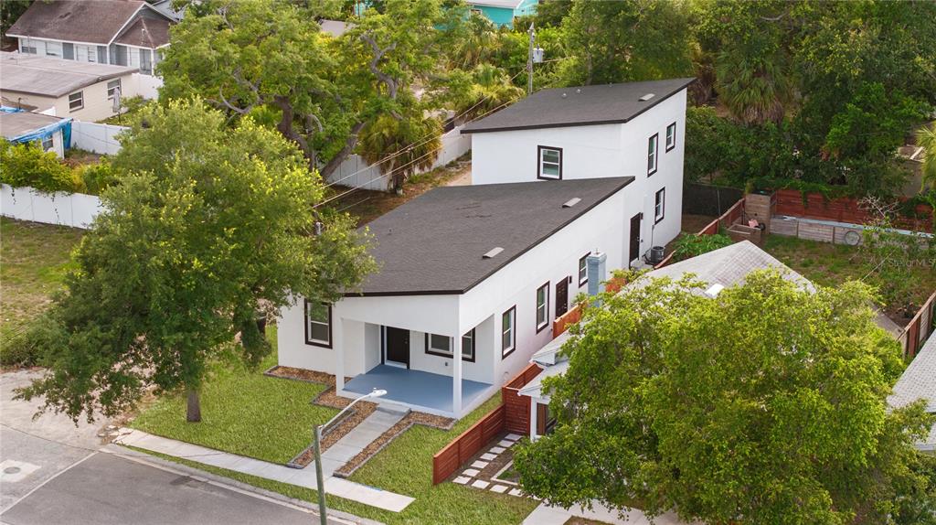 An aerial view shows a modern white two-story house with a flat roof and porch — 1421 35TH STREET S, ST PETERSBURG, FL