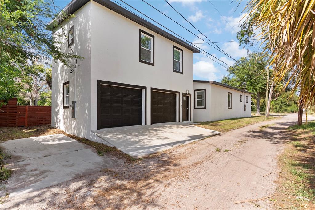 A two-story house with a two-car garage and a dirt driveway — 1421 35TH STREET S, ST PETERSBURG, FL