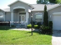 A single-story house with a gray exterior, a covered entryway, and a front lawn — OTHER CITY - IN THE STATE OF FLORIDA, FL