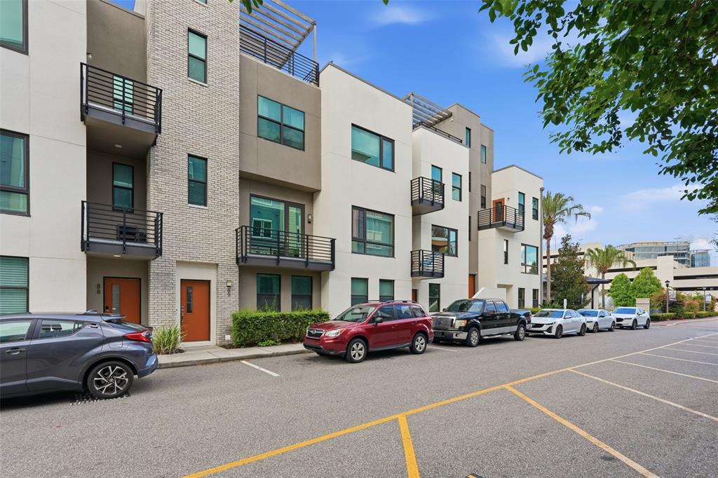 A row of modern multi-story townhomes with balconies and parking spaces in front — 2511 N GRADY AVENUE UNIT 89, TAMPA, FL