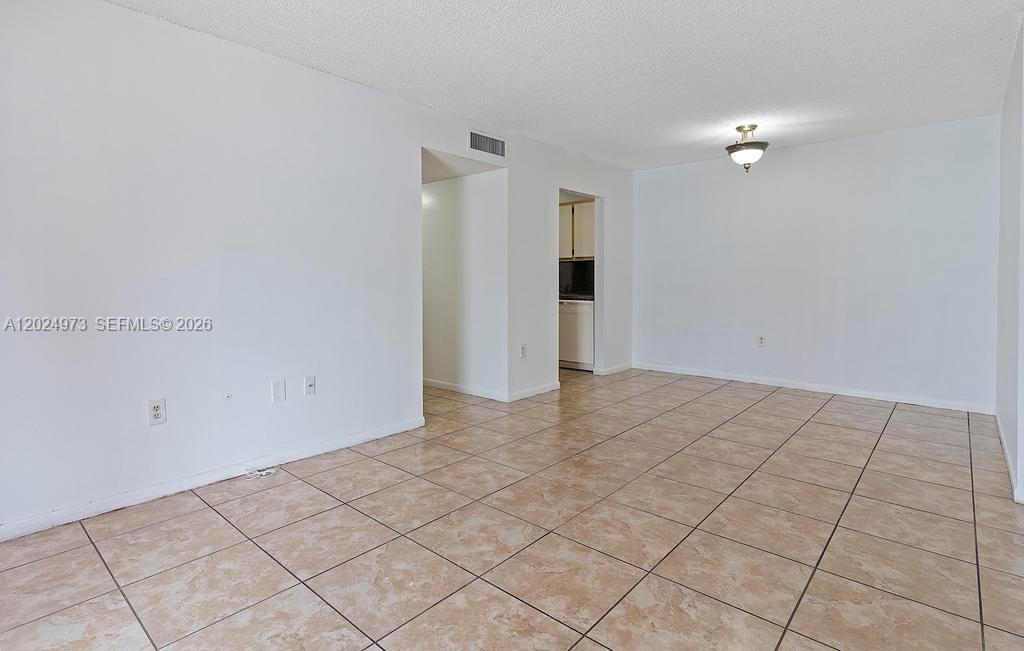 An empty room with white walls and light-colored square floor tiles — 7403 SW 152nd Ave # 2, Miami FL 33193, MIAMI, FL