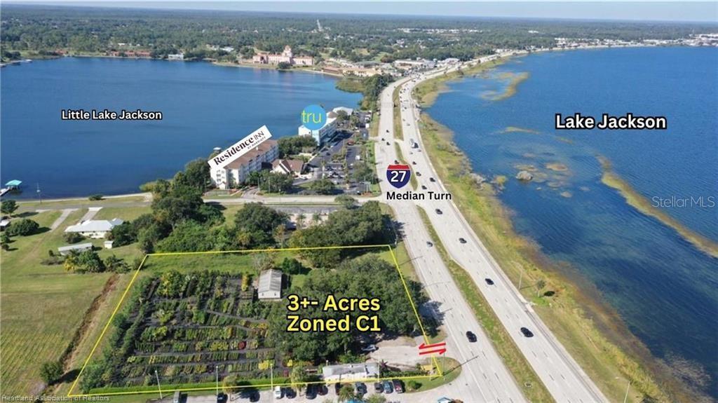 An aerial view shows a 3-acre commercial property located next to a highway and lakes — 1993 US HIGHWAY 27 S, SEBRING, FL