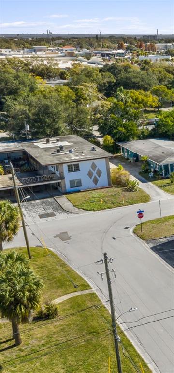An aerial view shows a two-story apartment building with a diamond-patterned facade near a street — 300 S NIMBUS AVENUE, CLEARWATER, FL