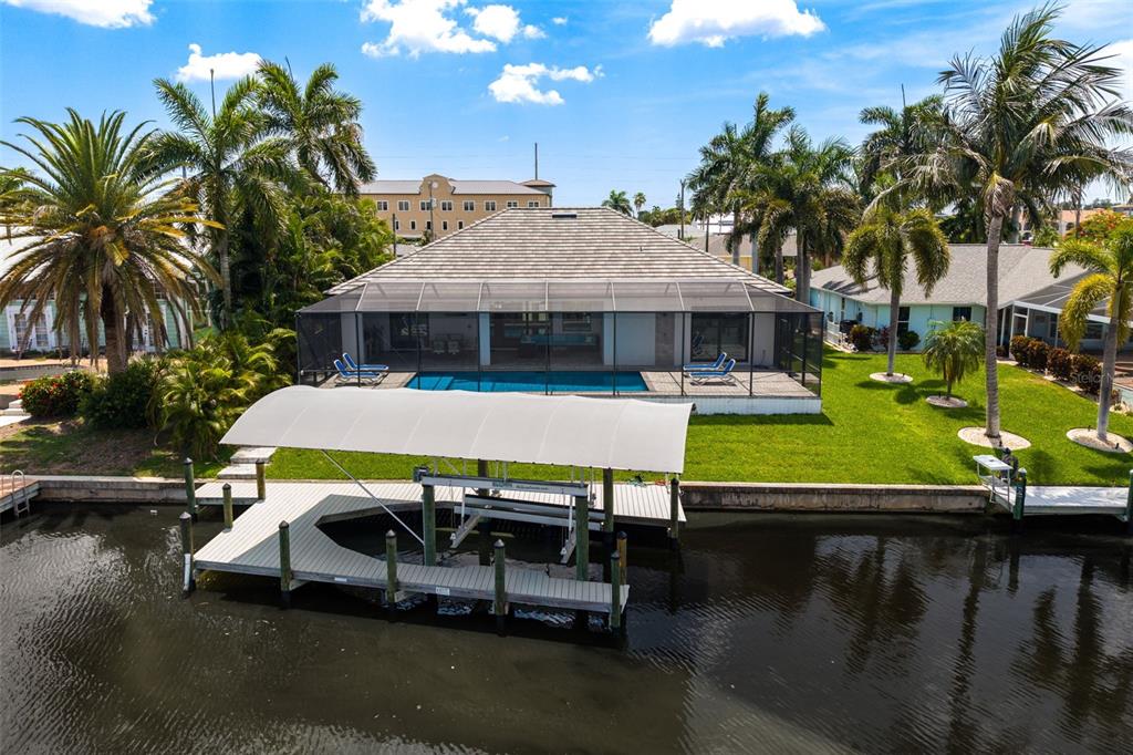 An aerial view of a waterfront house with a pool, screened lanai, and boat dock — 3619 SE 16TH PLACE, CAPE CORAL, FL