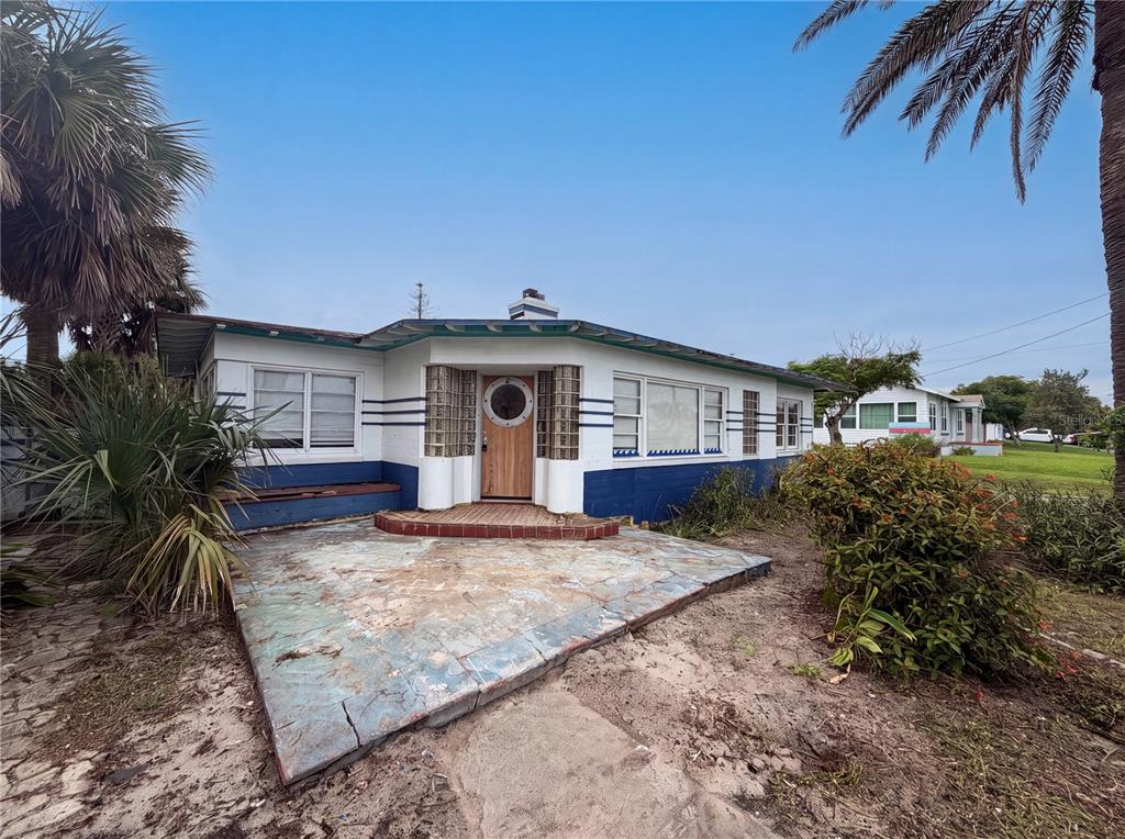 A single-story house with a blue and white exterior, glass block accents, and a patio — 370 HARTFORD AVENUE, DAYTONA BEACH, FL