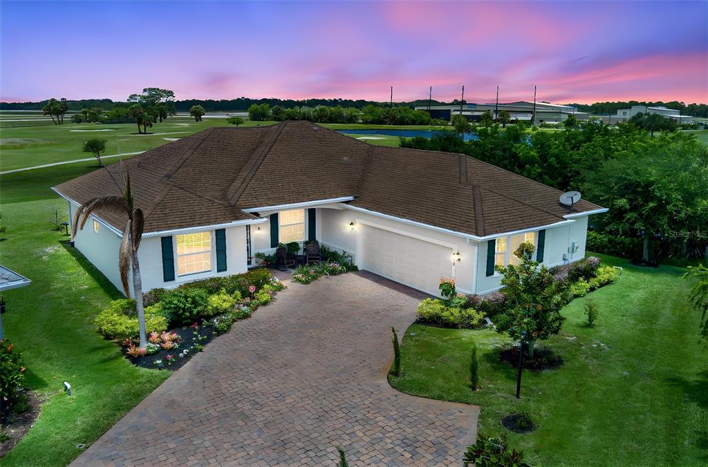 An aerial view of a single-story house with a brick driveway and a brown roof — 598 GOSSAMER WING WAY, SEBASTIAN, FL