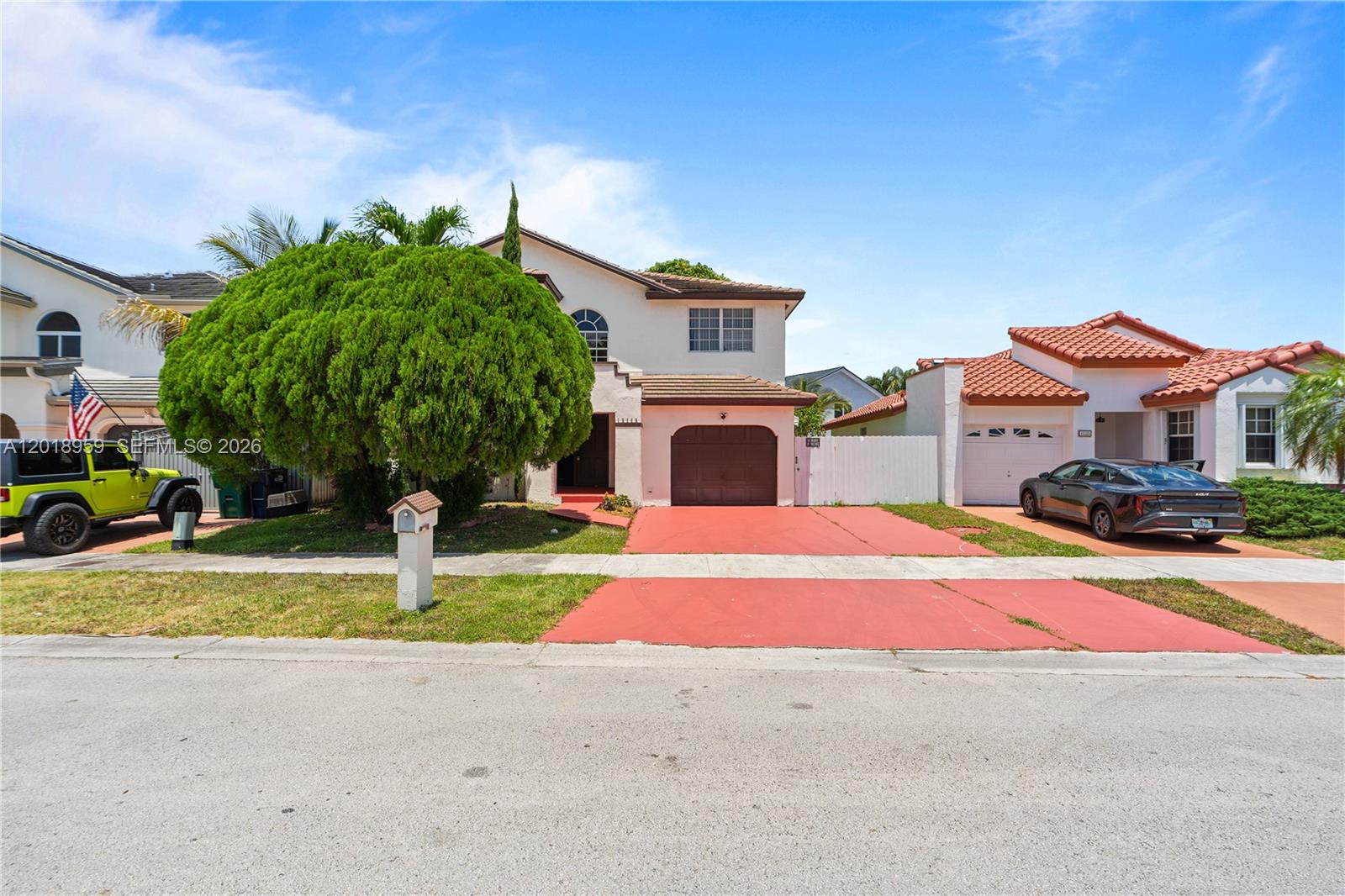 A two-story house with a red driveway, a large tree, and a garage — 15345 SW 63rd Ter, Miami FL 33193, MIAMI, FL