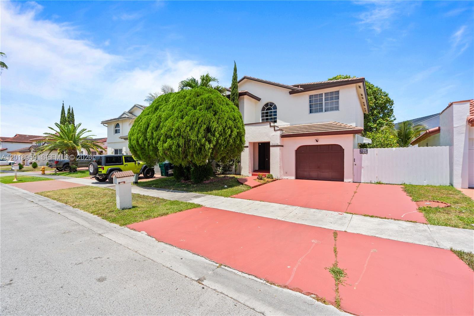 A two-story house features a red driveway, a large rounded tree, and a garage — 15345 SW 63rd Ter, Miami FL 33193, MIAMI, FL