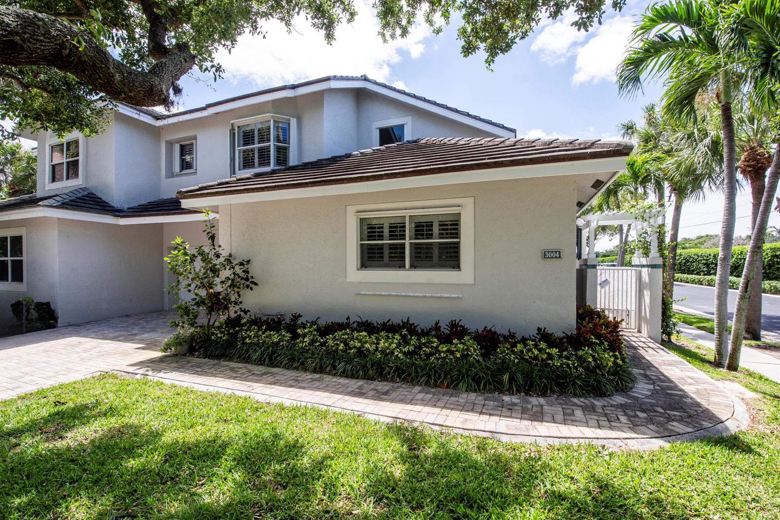 A two-story house with a paved walkway, landscaping, and a tile roof — 3004 Mainsail Circle, Jupiter FL 33477, JUPITER, FL