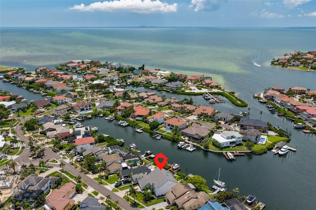 An aerial view shows waterfront houses with private docks along a canal near the ocean — 929 SYMPHONY ISLES BOULEVARD, APOLLO BEACH, FL