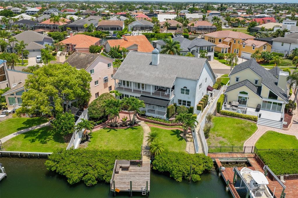 An aerial view of a waterfront house with a private dock and a boat lift — 929 SYMPHONY ISLES BOULEVARD, APOLLO BEACH, FL