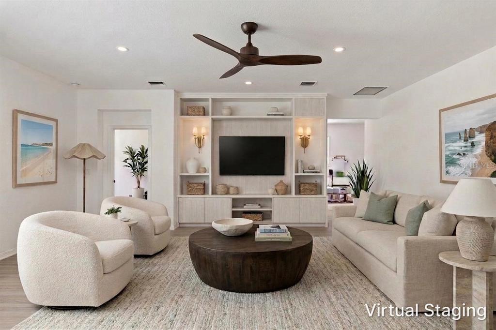 A living room features a built-in media center, a round coffee table, and two armchairs — 19689 FORT KING RUN, BROOKSVILLE, FL
