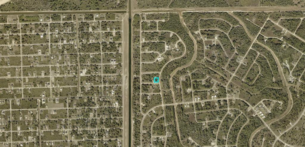 This is an aerial map showing a residential neighborhood with a highlighted property lot — 710 TUNNEY STREET, LEHIGH ACRES, FL