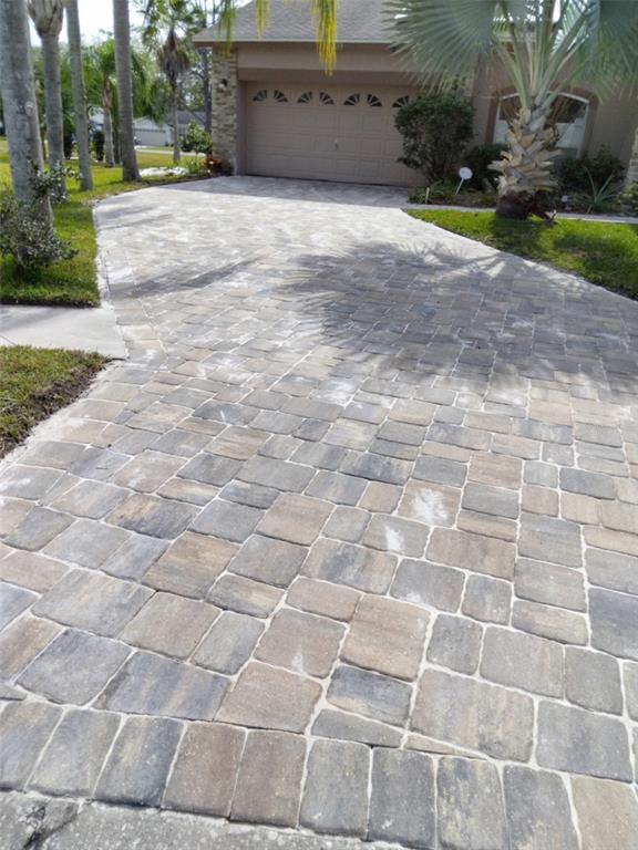 A paved driveway leads to a two-car garage in front of a residential home — 15301 MONTREAT WAY, TAMPA, FL