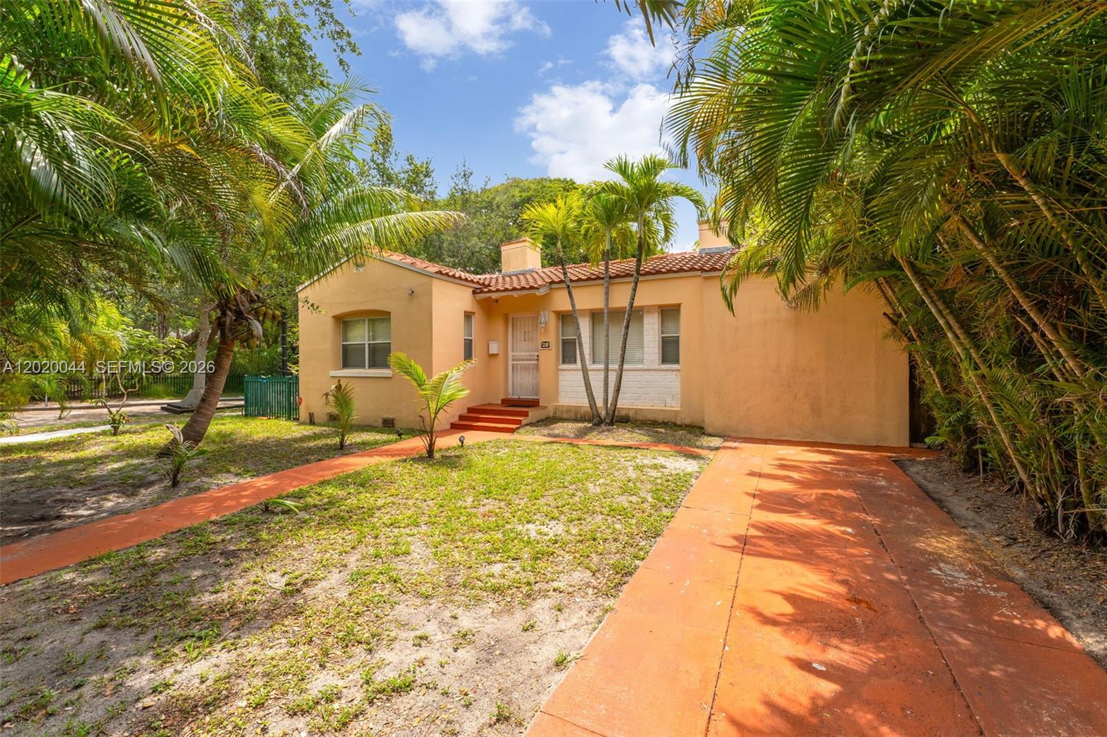 A single-story peach-colored house with a tile roof and a paved driveway — 28 NE 48th St, Miami FL 33137, MIAMI, FL