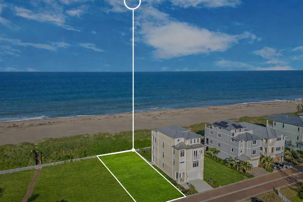 An aerial view shows a vacant rectangular lot situated next to a multi-story beach house — 5104 WATERSONG WAY, FORT PIERCE, FL