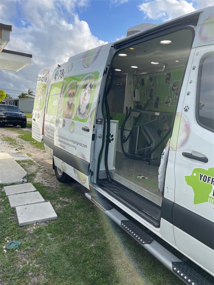 A mobile pet grooming van is parked outdoors with its side door open — 11700 SW Bird Road, Unincorporated Dade County FL 33175, UNINCORPORATED DADE COUNTY, FL