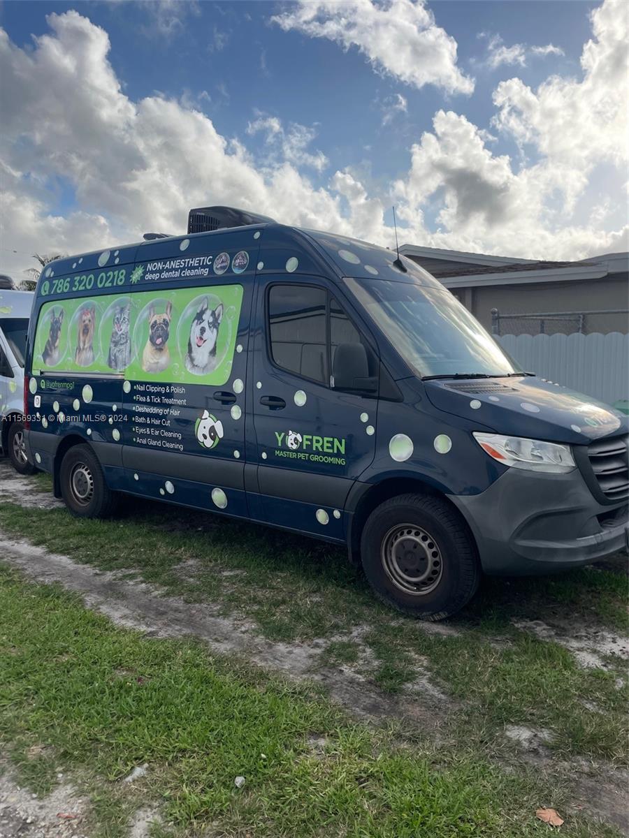 A dark blue mobile pet grooming van is parked on a grassy lot — 11700 SW Bird Road, Unincorporated Dade County FL 33175, UNINCORPORATED DADE COUNTY, FL