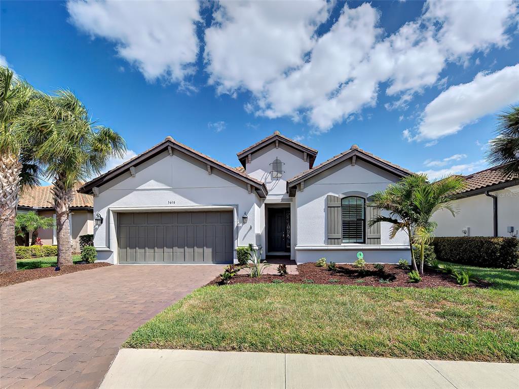 A single-story suburban house features a two-car garage, a paved driveway, and a front lawn — 5616 SCARLOTTI STREET, NOKOMIS, FL