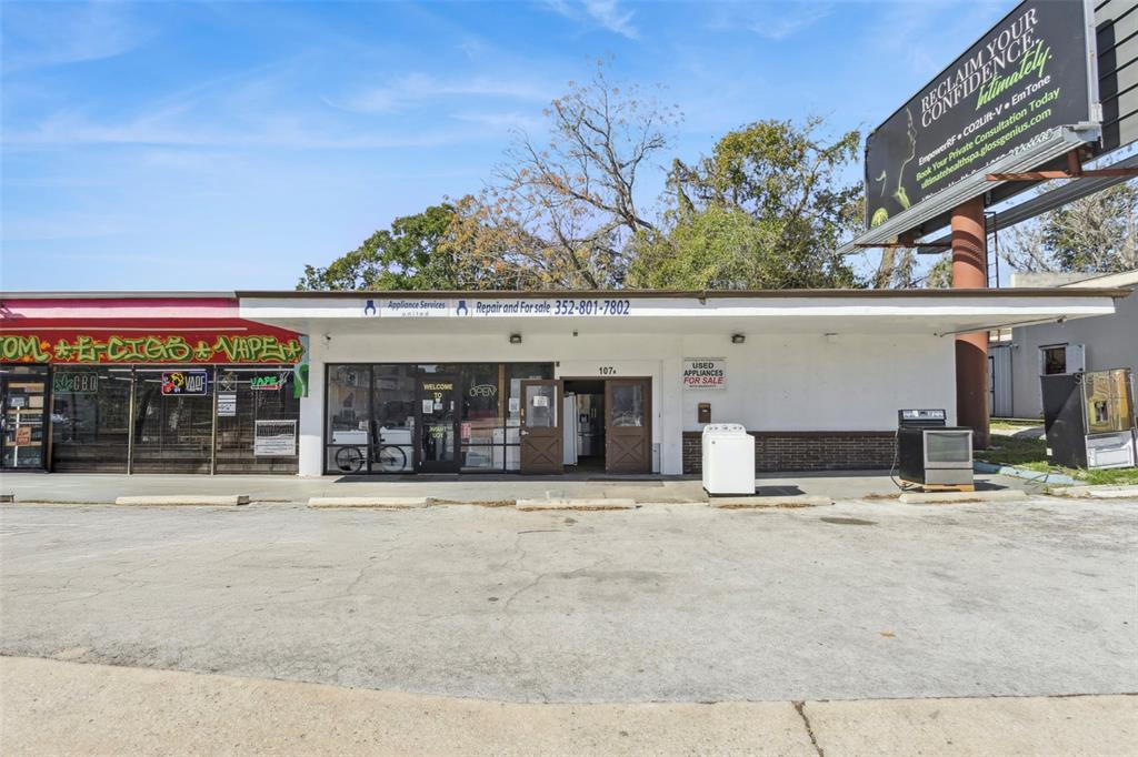 The exterior of a commercial building features a storefront with a parking lot in front — 107 S 14TH STREET, LEESBURG, FL