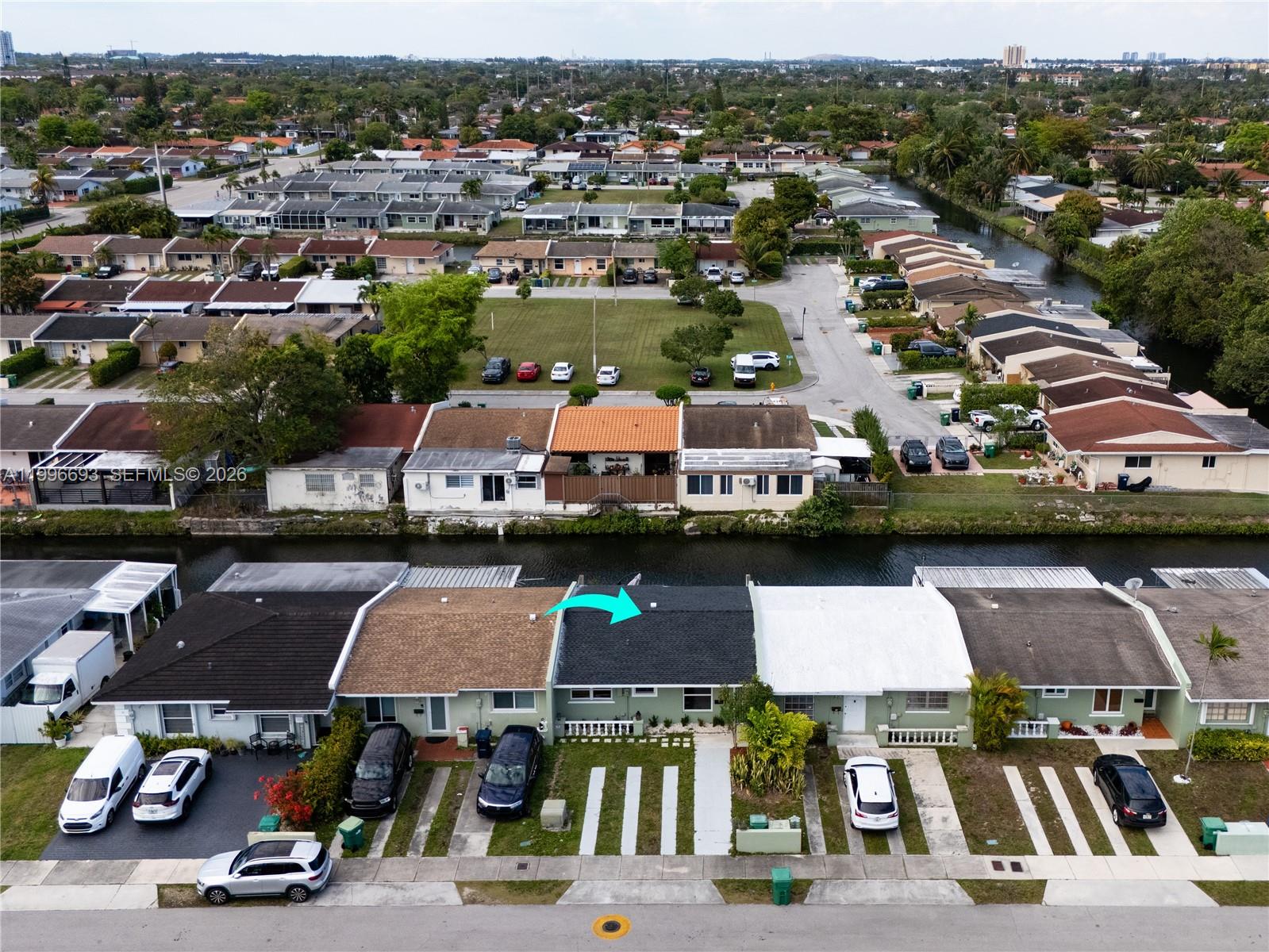 An aerial view shows a row of single-story townhouses with a canal in the foreground — 10017 SW 23rd Ter, Miami FL 33165, MIAMI, FL