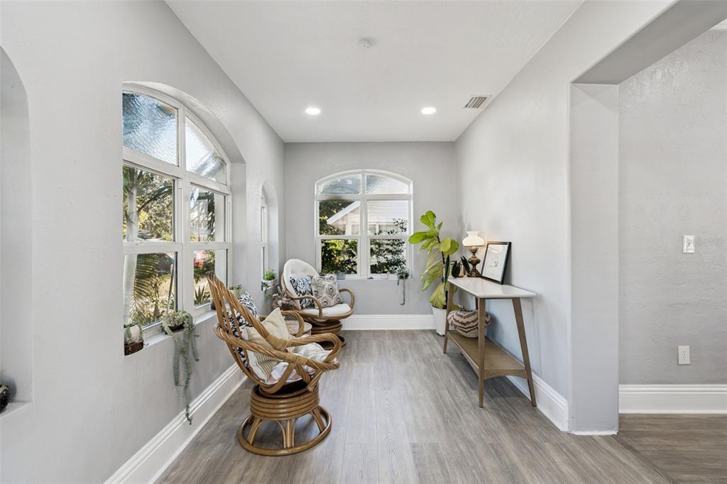 A blue house exterior features a bright yellow front door and patterned tile porch steps — 1120 17TH AVENUE N, ST PETERSBURG, FL