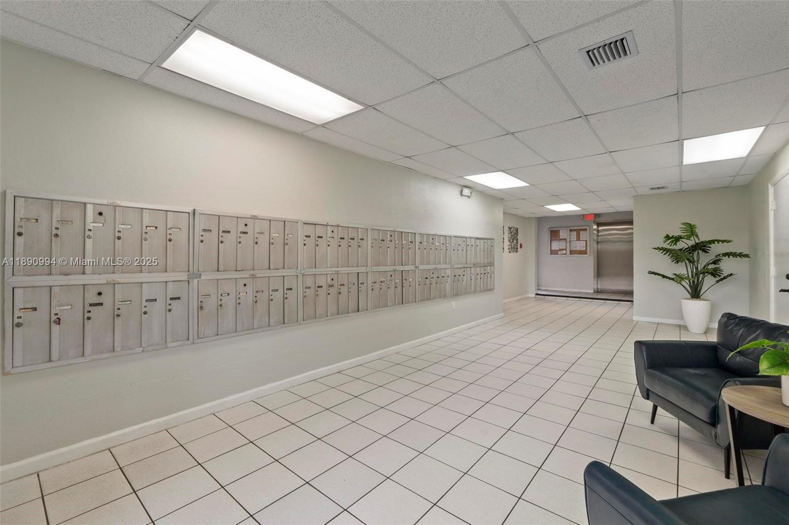 A lobby area features a wall of mailboxes, tiled floors, and leather seating — 1800 W 54th St # 109, Hialeah FL 33012, HIALEAH, FL