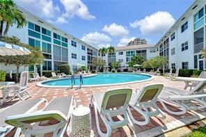A swimming pool sits in the center of a courtyard surrounded by multi-story apartment buildings — 1461 S Ocean Boulevard # 328, Pompano Beach FL 33062, POMPANO BEACH, FL