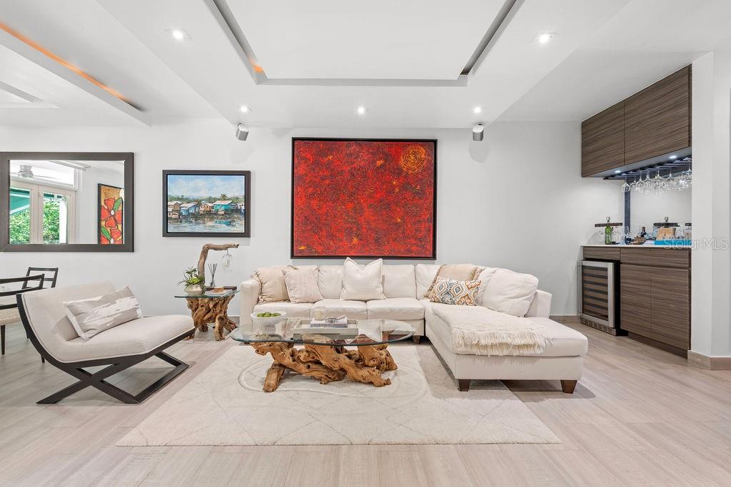 A modern living room features a white sectional sofa, a driftwood coffee table, and a bar — 693 PR UNIT 511, VEGA ALTA, PR