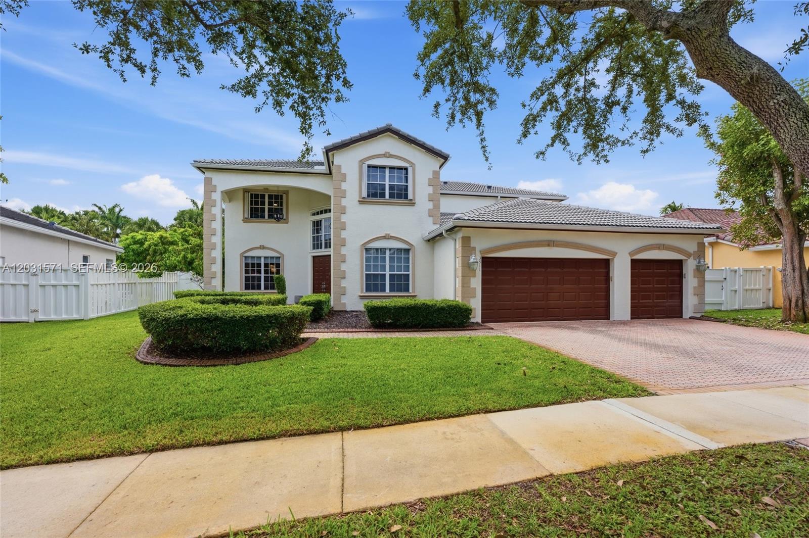 A two-story house with a beige stucco exterior, tiled roof, and a three-car garage — 3511 SW 145th Ave, Miramar FL 33027, MIRAMAR, FL