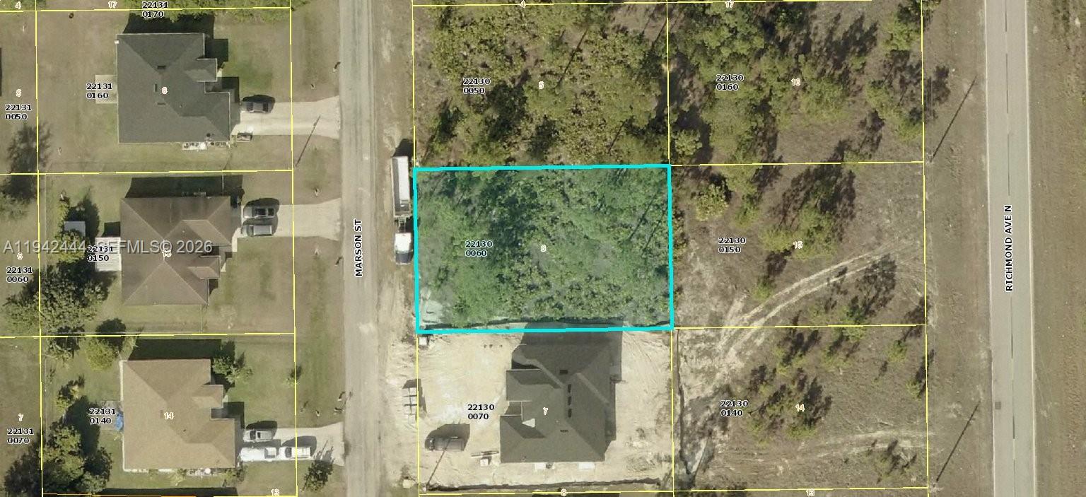This aerial map shows a vacant, wooded residential lot highlighted in blue between two streets — 1822 Marson, Lehigh Acres FL 33972, LEHIGH ACRES, FL