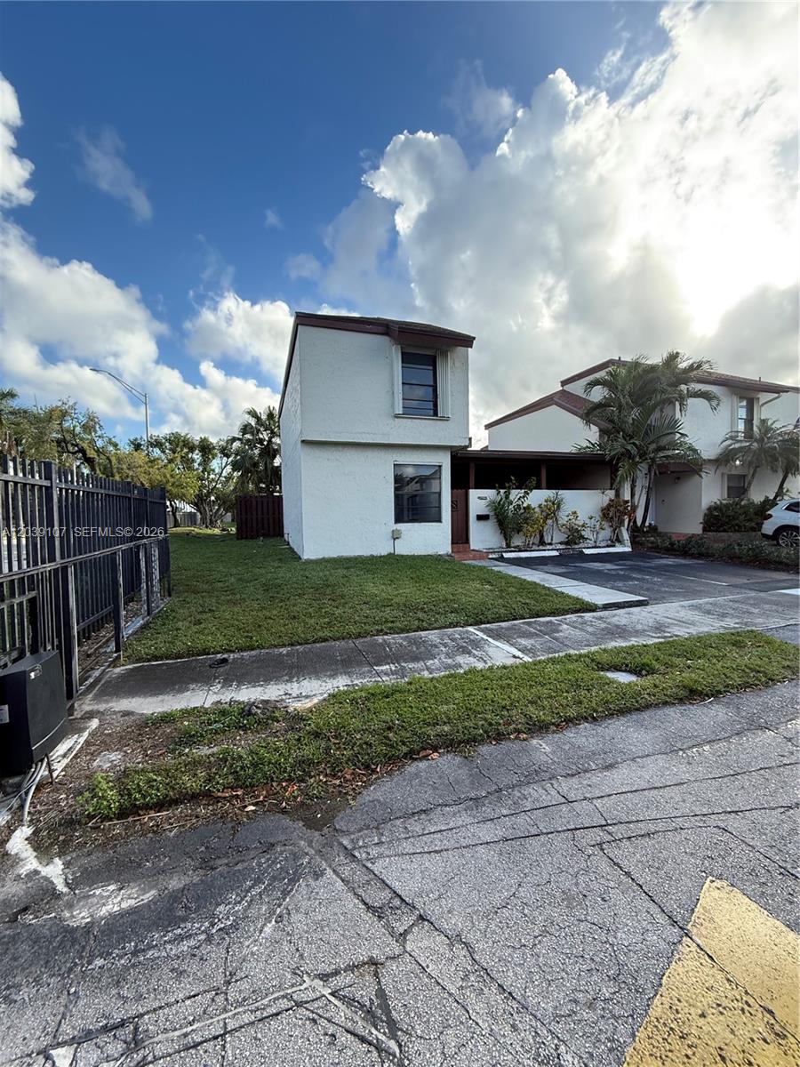 A two-story white townhouse with a side yard and a paved driveway — 9700 NW 6th Ln # 9700, Miami FL 33172, MIAMI, FL