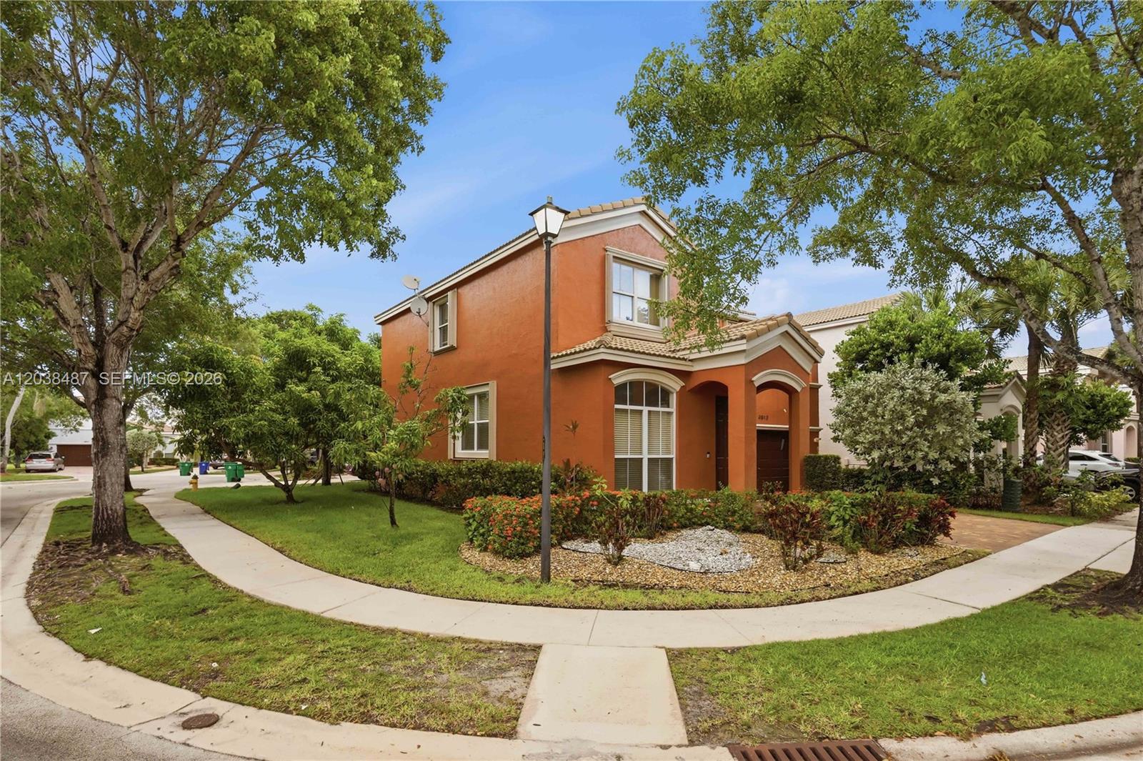 A two-story orange stucco house with a tiled roof sits on a corner lot — 4813 SW 155th Ter, Miramar FL 33027, MIRAMAR, FL