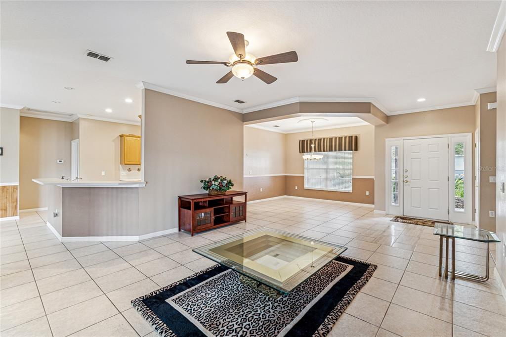 An aerial view shows a single-story house with a brown shingled roof and garage — 308 BEACON AVENUE, KISSIMMEE, FL