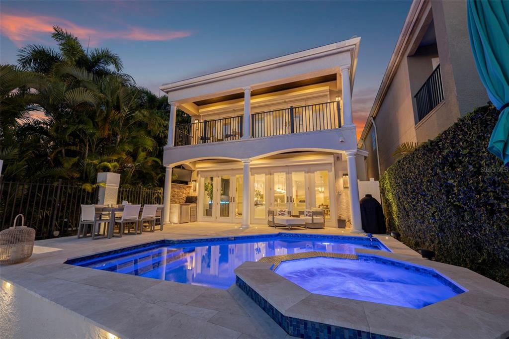 A two-story house exterior features a swimming pool, hot tub, and a covered patio area — 1009 ROYAL PASS ROAD, TAMPA, FL