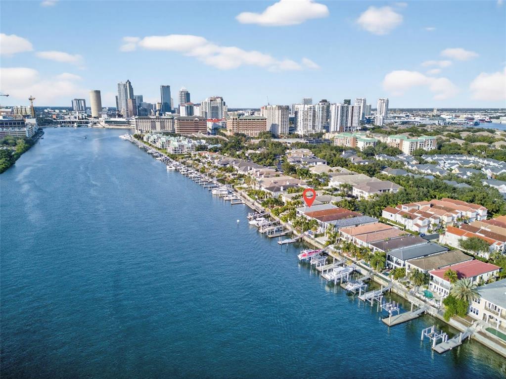 An aerial view shows a waterfront residential area with private boat docks along a river — 1009 ROYAL PASS ROAD, TAMPA, FL
