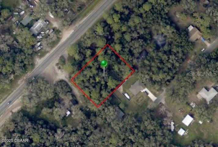 An aerial map view shows a rectangular, tree-covered lot outlined in red — 2884 W NEW YORK AVENUE, DELAND, FL