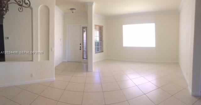 An interior view of a room with light-colored tile flooring, white walls, and an entryway — 12400 NW 78th Mnr # 0, Parkland FL 33076, PARKLAND, FL