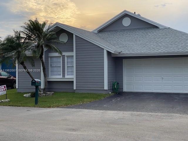 A gray, single-story house with a two-car garage and a palm tree in the yard — 10304 SW 139th Pl, Miami FL 33186, MIAMI, FL
