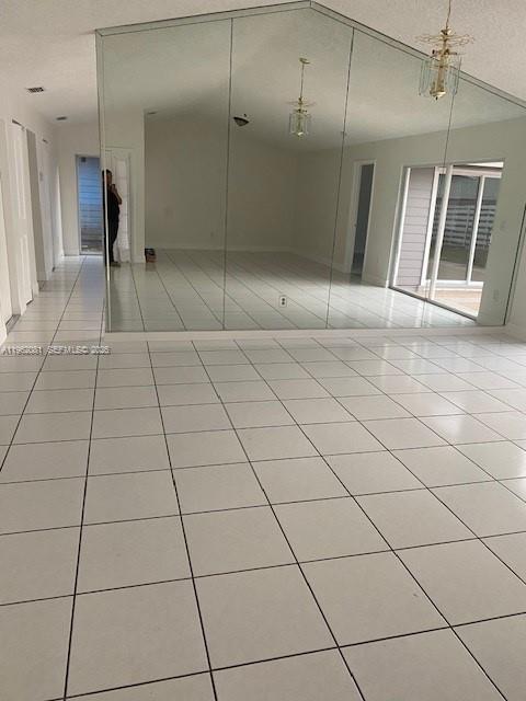 A room with white tiled floors and a large wall of mirrored panels — 10304 SW 139th Pl, Miami FL 33186, MIAMI, FL